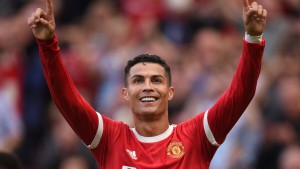 (FILES) This file photo taken on September 11, 2021 shows Manchester United's Portuguese striker Cristiano Ronaldo celebrating after scoring their second goal during the English Premier League football match between Manchester United and Newcastle at Old Trafford in Manchester, north west England. - Lionel Messi appears to be the favourite to succeed himself and win a seventh Ballon d'Or on November 29, 2021 at the Theatre du Chatelet in Paris, where only Robert Lewandowski and Karim Benzema appear to be able to prevent this consecration. (Photo by Oli SCARFF / AFP) / RESTRICTED TO EDITORIAL USE. No use with unauthorized audio, video, data, fixture lists, club/league logos or 'live' services. Online in-match use limited to 120 images. An additional 40 images may be used in extra time. No video emulation. Social media in-match use limited to 120 images. An additional 40 images may be used in extra time. No use in betting publications, games or single club/league/player publications. /